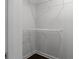 An empty closet with dark wood laminate flooring, painted white walls, and standard wire shelving at 1882 Rosewood Rd, Decatur, GA 30032