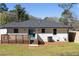 A view of the rear of the house, featuring a well-maintained yard, a deck, and fresh paint at 1882 Rosewood Rd, Decatur, GA 30032