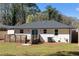 A view of the rear of the house, featuring a well-maintained yard, a deck, and fresh paint at 1882 Rosewood Rd, Decatur, GA 30032