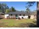 A view of the rear of the house, featuring a well-maintained yard, a deck, and fresh paint at 1882 Rosewood Rd, Decatur, GA 30032