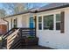 Charming exterior with a bright blue door, white brick, wood shutters, and a flower box at 1882 Rosewood Rd, Decatur, GA 30032
