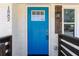Striking blue front door with windows and a side light fixture, creates a warm and welcoming entrance at 1882 Rosewood Rd, Decatur, GA 30032