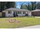 Beautifully landscaped front yard of white brick home with charming curb appeal at 1882 Rosewood Rd, Decatur, GA 30032