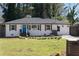 Charming home with a well-manicured lawn and a bright blue front door, creating a welcoming curb appeal at 1882 Rosewood Rd, Decatur, GA 30032