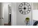 A hallway features a large decorative clock and a modern glass table at 1882 Rosewood Rd, Decatur, GA 30032