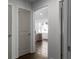 Hallway view with grey interior doors and dark wood flooring leading to a naturally lit room at 1882 Rosewood Rd, Decatur, GA 30032