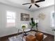 A light and bright home office features a glass top desk and modern decor at 1882 Rosewood Rd, Decatur, GA 30032