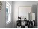 A bright and stylish home office with black shelving units and neutral artwork at 1882 Rosewood Rd, Decatur, GA 30032