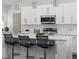 Modern kitchen features a large island with seating, white cabinets, and stainless steel appliances at 1882 Rosewood Rd, Decatur, GA 30032