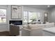 Bright living room featuring a modern fireplace, large windows, and comfortable, stylish seating arrangements at 1882 Rosewood Rd, Decatur, GA 30032
