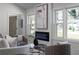 Cozy living room featuring a modern fireplace, large windows, and contemporary decor and furniture at 1882 Rosewood Rd, Decatur, GA 30032