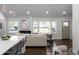 Well-lit living room with an electric fireplace and an adjacent open kitchen with bar stool seating at 1882 Rosewood Rd, Decatur, GA 30032