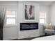 Sunlit bedroom showcases a modern fireplace, flanked by windows, creating a warm and inviting space at 1882 Rosewood Rd, Decatur, GA 30032