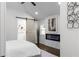Inviting bedroom with vaulted ceilings, decorative fireplace and sliding barn door leading to bathroom at 1882 Rosewood Rd, Decatur, GA 30032