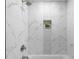 A beautifully tiled shower features marble and mosaic tiles and a built in niche at 1882 Rosewood Rd, Decatur, GA 30032