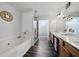 Contemporary bathroom with a soaking tub, shower, double sink vanity, and modern fixtures at 2026 Ellison Nw Way # 13, Kennesaw, GA 30152