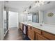 Bright bathroom with a double vanity, modern lighting fixtures, and a marble-tiled shower, offering a luxurious feel at 2026 Ellison Nw Way # 13, Kennesaw, GA 30152