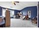 Bright bedroom with blue accent wall, ceiling fan, carpet, and large windows at 2026 Ellison Nw Way # 13, Kennesaw, GA 30152