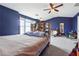 Large bedroom with dark blue walls, vaulted ceiling, and soft carpeting at 2026 Ellison Nw Way # 13, Kennesaw, GA 30152