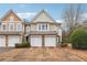 Charming townhome featuring a two-car garage and a well-manicured front yard at 2026 Ellison Nw Way # 13, Kennesaw, GA 30152