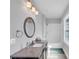 This bathroom has grey walls, vanity with granite countertop, a shower and bathtub with a white tile surround at 3020 Barnes Mill Ct, Roswell, GA 30075