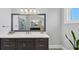 Bathroom vanity with double sinks, white countertop, dark cabinetry and large framed mirror at 3020 Barnes Mill Ct, Roswell, GA 30075