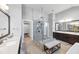 This bathroom features double vanities with framed mirrors and a frameless glass shower at 3020 Barnes Mill Ct, Roswell, GA 30075