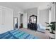 Bright bedroom with a blue accent blanket, plants, and gray walls at 3020 Barnes Mill Ct, Roswell, GA 30075