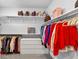 Walk-in closet with custom shelving, drawers, and ample hanging space for clothes and accessories at 3020 Barnes Mill Ct, Roswell, GA 30075