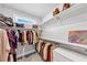 Walk-in closet with custom shelving, drawers, and ample hanging space for clothes and accessories at 3020 Barnes Mill Ct, Roswell, GA 30075