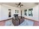 Covered patio features a dining table, ceiling fan, BBQ grill and outdoor seating at 3020 Barnes Mill Ct, Roswell, GA 30075