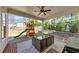 Stylish covered patio with a dining table and chairs, ceiling fan, and barbecue grill at 3020 Barnes Mill Ct, Roswell, GA 30075