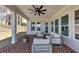Covered patio featuring brick flooring, ceiling fan, and outdoor seating area at 3020 Barnes Mill Ct, Roswell, GA 30075
