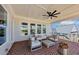Relaxing covered patio with comfortable seating, ceiling fan, and neighborhood views at 3020 Barnes Mill Ct, Roswell, GA 30075