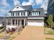 Stunning two-story white brick home with a two-car garage and beautiful landscaped front yard at 3020 Barnes Mill Ct, Roswell, GA 30075