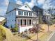 Beautiful two-story white home with a large front porch and nicely landscaped yard and neighborhood at 3020 Barnes Mill Ct, Roswell, GA 30075