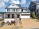Beautiful two-story white home with a two-car garage and nicely landscaped front yard at 3020 Barnes Mill Ct, Roswell, GA 30075
