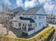 Aerial view of the home's exterior showing a covered patio, spacious yard, and beautiful landscaping at 3020 Barnes Mill Ct, Roswell, GA 30075
