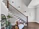 Beautiful foyer with hardwood floors, staircase with black iron railings, and stylish decor at 3020 Barnes Mill Ct, Roswell, GA 30075