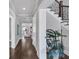 Hallway featuring dark hardwood floors, light gray walls, and a staircase at 3020 Barnes Mill Ct, Roswell, GA 30075