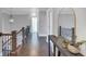 The upstairs hallway features hardwood floors, dark wood railings and bright neutral-colored walls at 3020 Barnes Mill Ct, Roswell, GA 30075