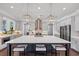 Bright kitchen featuring a large island, quartz countertops, stainless steel appliances, and modern pendant lighting at 3020 Barnes Mill Ct, Roswell, GA 30075