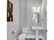 Powder room with patterned floor tiles and white pedestal sink at 3020 Barnes Mill Ct, Roswell, GA 30075