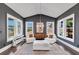 Inviting sunroom with vaulted ceiling, stylish decor, and abundant natural light, perfect for relaxation and enjoyment at 3020 Barnes Mill Ct, Roswell, GA 30075