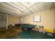 Unfinished basement with ping pong table, weight bench, and storage bins at 4130 N Quail Dr, Douglasville, GA 30135