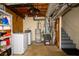 Unfinished basement laundry area with washer, dryer, water heater, and furnace at 4130 N Quail Dr, Douglasville, GA 30135