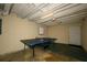 Unfinished basement with ping pong table and overhead lighting at 4130 N Quail Dr, Douglasville, GA 30135