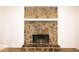 Close-up of a charming stone fireplace, complete with a mantel, adding warmth and character to the living space at 4130 N Quail Dr, Douglasville, GA 30135