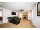 Relaxing living room with a stone fireplace, plush carpet, ceiling fan, and comfortable leather furniture at 4130 N Quail Dr, Douglasville, GA 30135