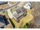 Aerial view of a residential property featuring a deck, expansive backyard, and mature trees at 5977 Wildcreek Rd, Sugar Hill, GA 30518